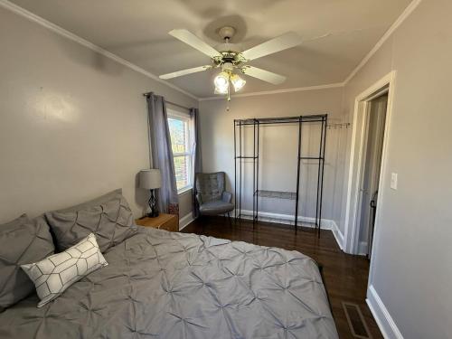 a bedroom with a bed and a ceiling fan at Cozy 1 Bedroom Bungalow in Charlotte