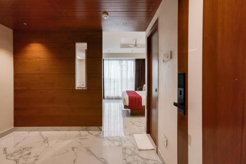 a hallway with a door leading to a bedroom at Hotel Vilvah in Coimbatore