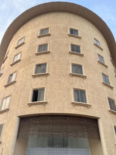 a tall building with windows on the side of it at صفاء المسكن in Dammam