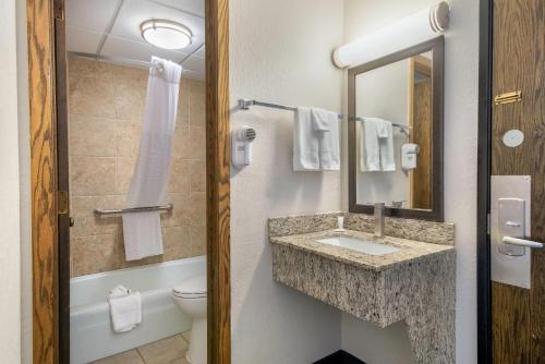 a bathroom with a sink and a toilet at Days Inn by Wyndham International Falls in International Falls