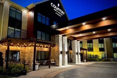 a building with a sign on the front of it at Country Inn & Suites by Radisson, Appleton Airport - Fox River Mall Area in Appleton