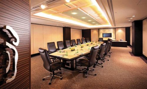 a conference room with a long table and chairs at Regal Airport Hotel in Hong Kong