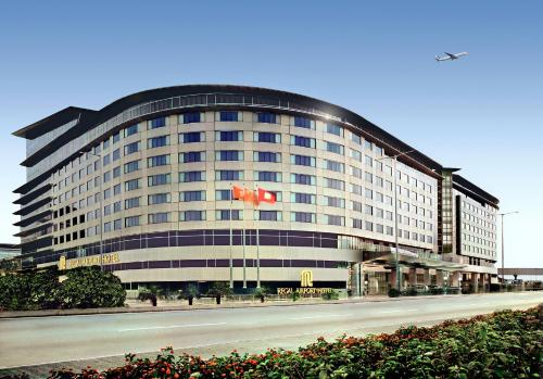 a large building with a canadian flag on it at Regal Airport Hotel in Hong Kong