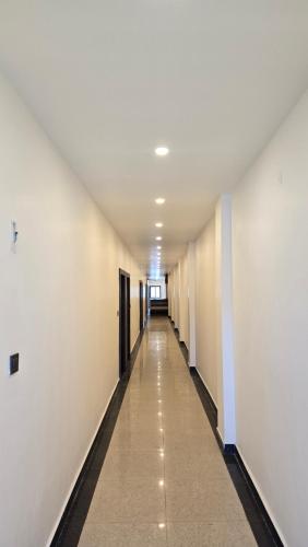 a hallway of an office building with a long corridor at SHRI DIVYAM Hotel & Restaurant in Bhopal