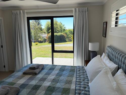 a bedroom with a bed and a large sliding glass door at The Cottage at 105 in Redwoods Valley