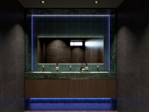 a bathroom with three sinks and a mirror at Brisdale International Kuala Lumpur in Kuala Lumpur