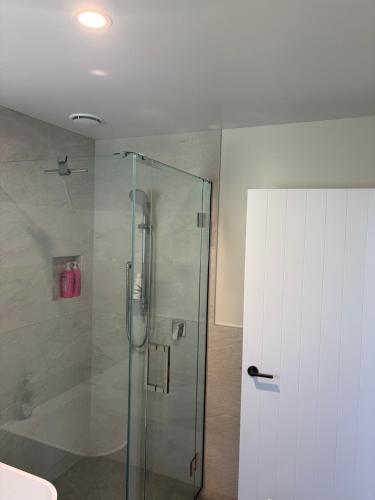 a shower with a glass door in a bathroom at The Cottage at 105 in Redwoods Valley