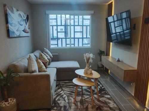 a living room with a couch and a table at New apartment, near the AIFA in Santa Cruz Tecamac