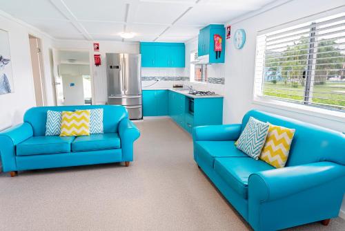 a kitchen with two blue couches in a room at Ingenia Holidays Conway Beach in Conway