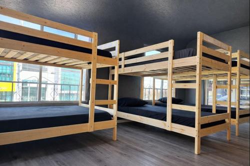 a room with three bunk beds in a building at Hoover Vibe Near Public Transportation in Los Angeles