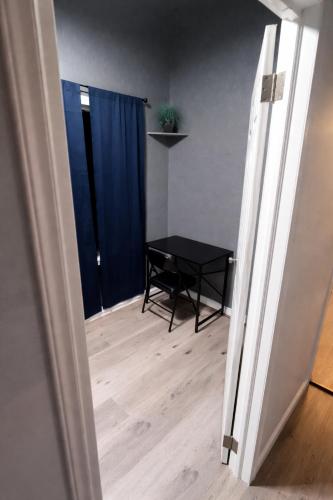 a room with a table and a blue curtain at Hoover Vibe Near Public Transportation in Los Angeles