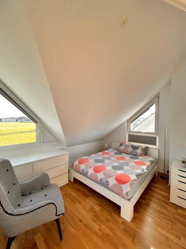 a bedroom with a bed and a chair at Sunshine in Messen