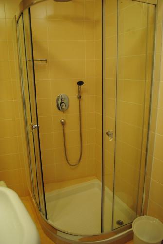 a shower with a glass door in a bathroom at Rooms Piazzetta in Cres