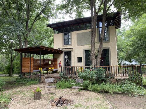 a house with a gazebo in front of it at Porcupine House in Magaliesburg