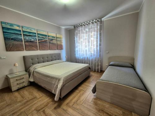 a bedroom with two beds and a window at Appartamento Campanella in Isola Capo Rizzuto