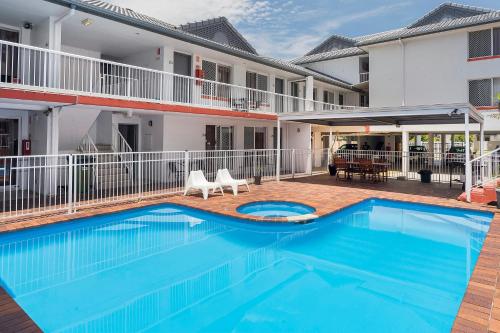 a swimming pool in front of a building at Sunshine Beach Resort in Gold Coast