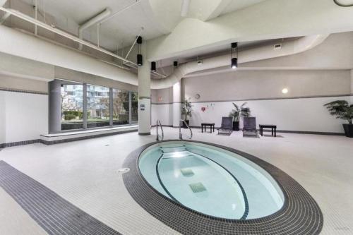 a pool in the middle of a room at BC Place & Rogers Arena Downtown Modern Condo in Vancouver