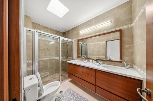 a bathroom with a toilet and a sink and a shower at Villa Ella in Eilat