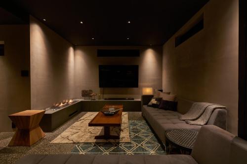 a living room with a couch and a table at N3 Tsuchiura CYCLE HOME HOTEL in Tsuchiura