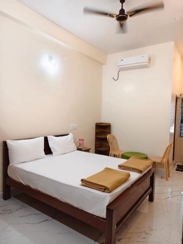 a bedroom with a bed and a ceiling fan at AalaGo in Thiruchendur