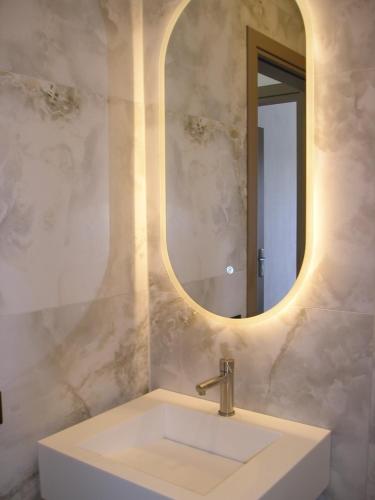 a bathroom with a sink and a mirror at Golden Beach Inn in Chrysi Ammoudia