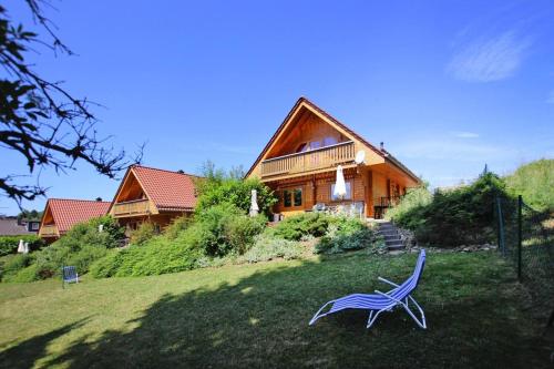 a blue chair in the yard in front of a house at Blockhaus, Bad Sachsa in Steina