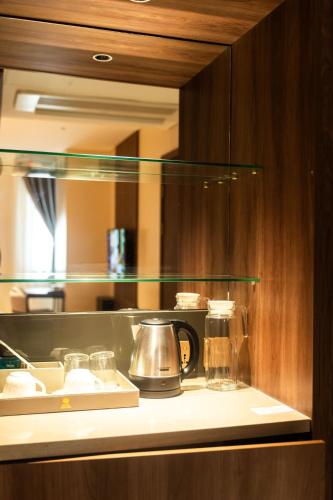 a kitchen with a counter top with a coffee maker at Hotel George in Cebu City