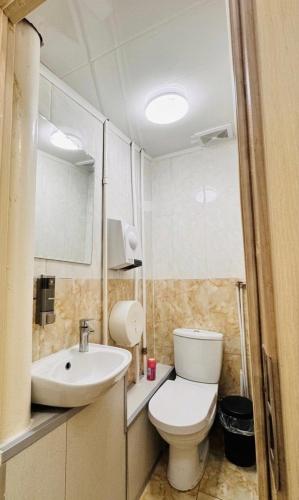 a bathroom with a toilet and a sink at Khongor Guest house & Tours in Ulaanbaatar