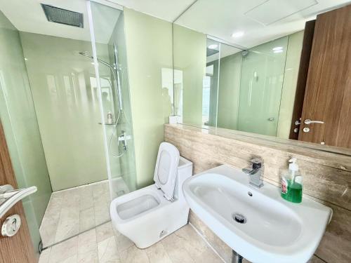 a bathroom with a sink and a toilet and a shower at Vortex Suites KLCC by Chia in Kuala Lumpur