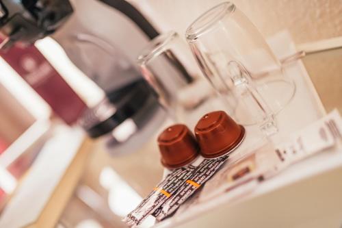 a close up of a blender with two bottles on it at Hostal Cortés in Cuenca