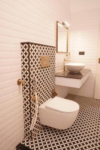 a bathroom with a toilet and a sink at The Polaris in Cochin