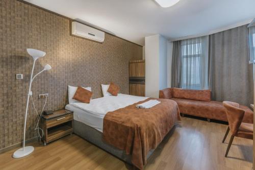 a hotel room with a bed and a couch at Hotel Atabay in Istanbul