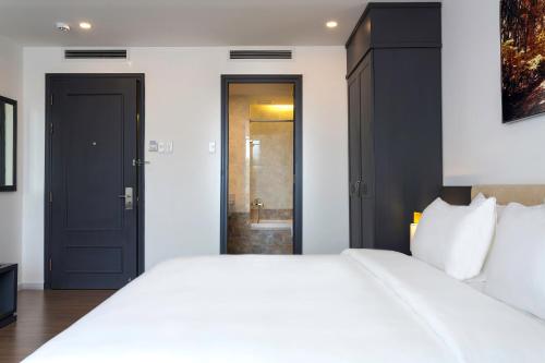 Ένα ή περισσότερα κρεβάτια σε δωμάτιο στο Calista Sai Gon Hotel