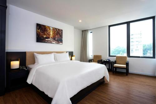 Ένα ή περισσότερα κρεβάτια σε δωμάτιο στο Calista Sai Gon Hotel