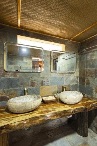 two sinks on a wooden counter in a bathroom at Fullhouse Mộc Châu in Mộc Châu