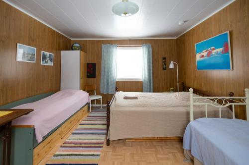 a bedroom with two beds and a window at Heidin Mummola Farm in Turtola