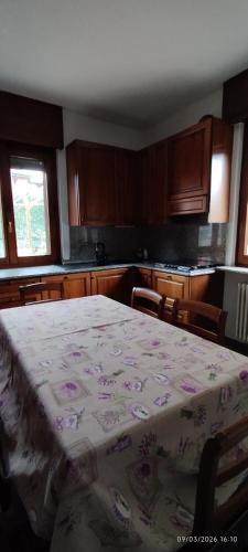 a kitchen with a table with a blanket on it at Casa GALLI Como in Colverde