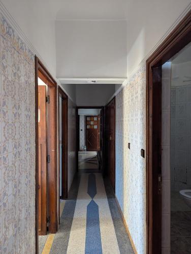a hallway of a room with ailed floor and a sink at Hostel Assafar in Ouarzazate