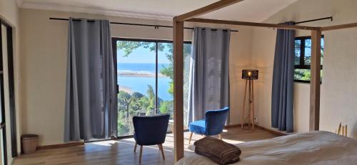 a bedroom with a bed and a large window at Villa Alba in Margate