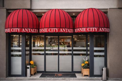 a store front with red domes over the doors at Bonnie City Hotel in Antalya
