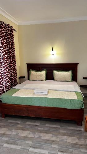a bedroom with a large bed in a room at Karibu Resort Sipi in Kapchorwa