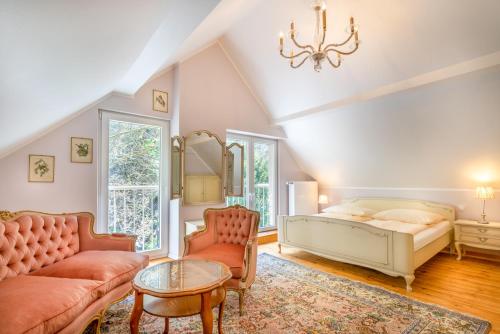 a bedroom with a bed and a couch and a table at Romantisches Hotel zur Post in Brodenbach
