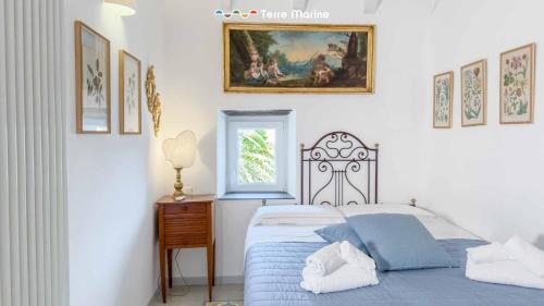 a bedroom with a bed and a window at La Galleria del Tempo, Terre Marine in Portovenere