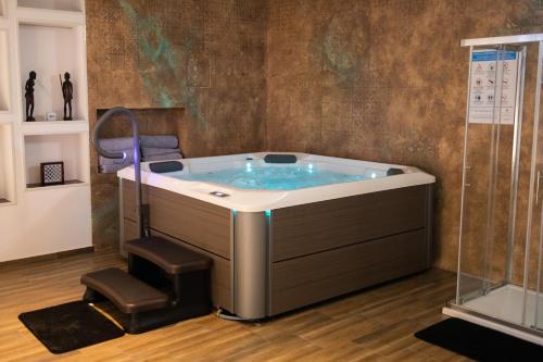 a jacuzzi tub in a room with a chair at Private Vineyard Villa with Heated Pool, Spa & BBQ by Destination GREEN Croatia in Velika