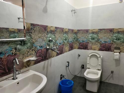 a bathroom with a toilet and a sink at Domukha pali ghar in Chepti