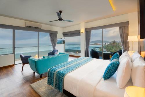 a bedroom with a bed with a view of the ocean at Sandy Bliss Mirissa in Mirissa