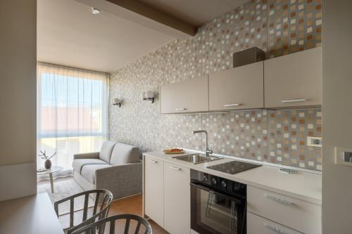 a kitchen with a sink and a stove top oven at Franz Apartments in Ilirska Bistrica
