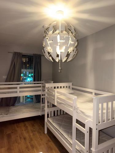 a bedroom with two bunk beds and a chandelier at Hostel & home Marlborough street in Dublin