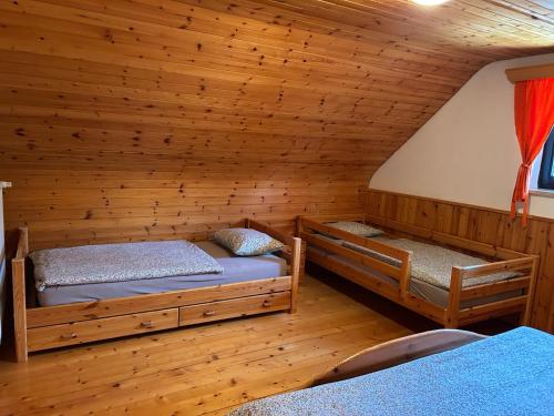 a room with two beds in a log cabin at Chalet Rozika Rogla in Zreče