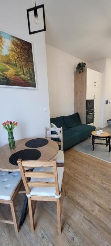 a living room with a table and chairs and a couch at Apartament 39 in Lublin